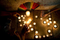<p>Members LGBT community light candles in solidarity with Florida’s shooting attack victims, in Tel Aviv, Israel, June 12, 2016. (AP Photo/Oded Balilty) </p>