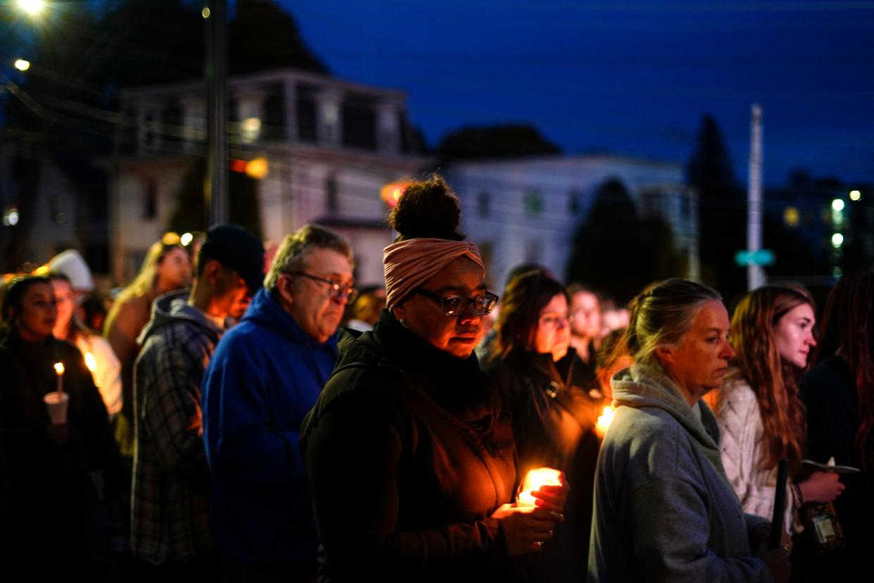 People gather at a vigil for the victims of Wednesday's mass shootings, Sunday, Oct. 29, 2023, outside the Basilica of Saints Peter and Paul in Lewiston, Maine.