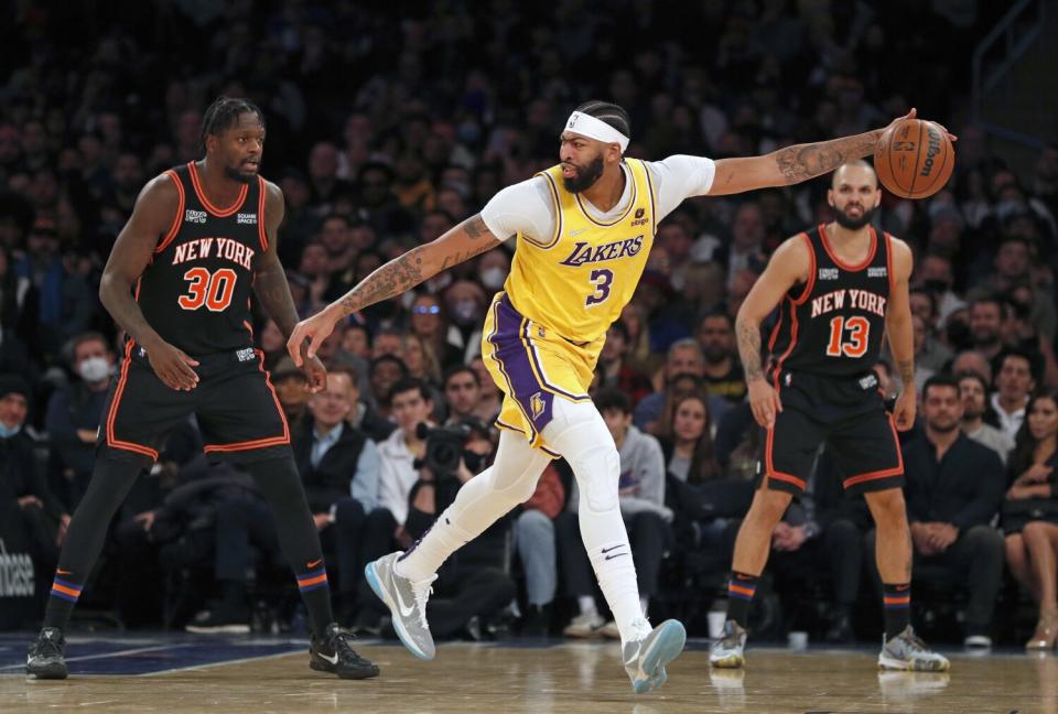 Lakers' Anthony Davis controls the ball during the second half against New York Knicks' Julius Randle and Evan Fournier.