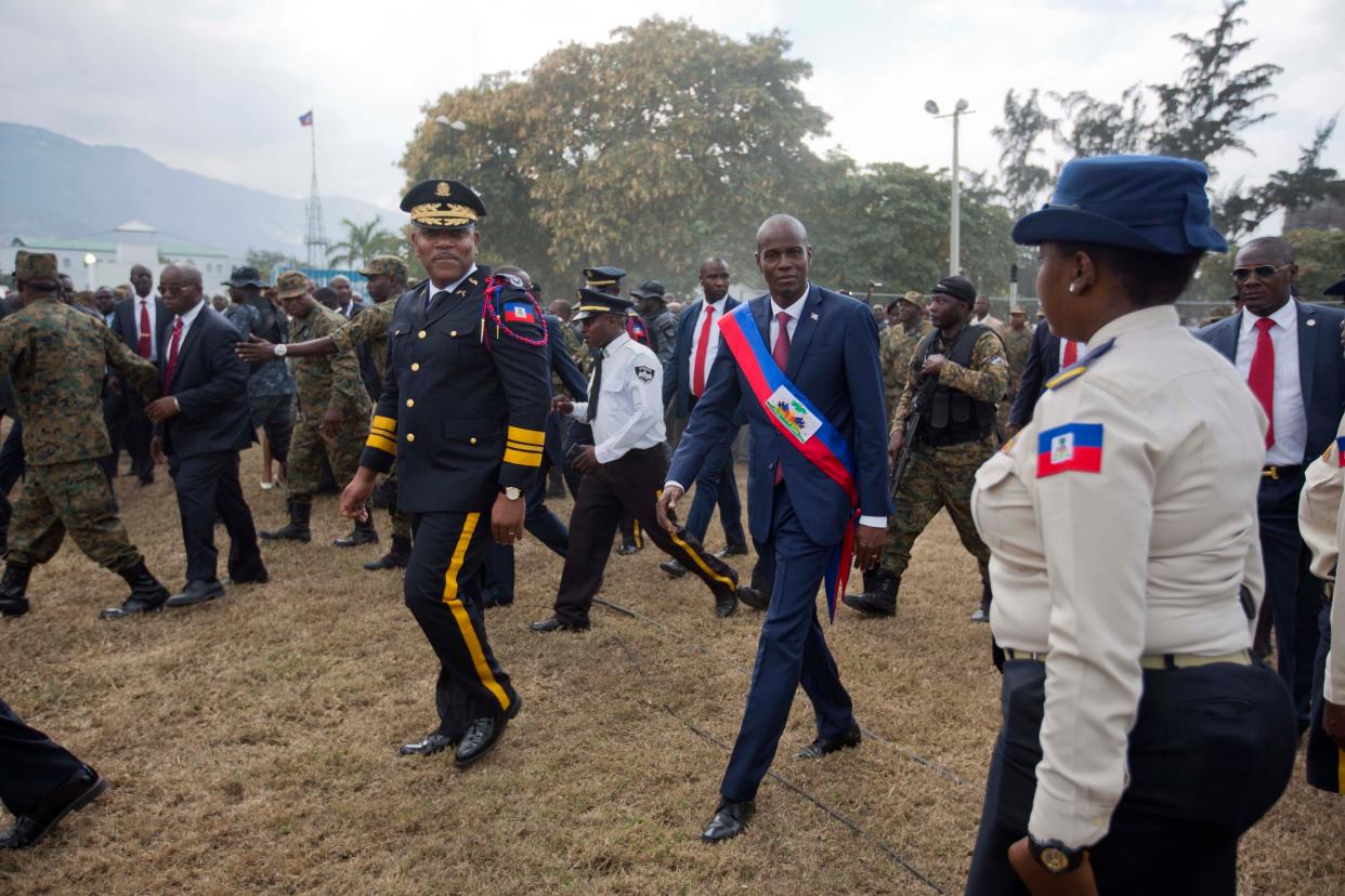 Newly sworn-in Haitian President Jovenel Moise walks with Police Chief Michel-Ange Gedeon past National Police at the National Palace after his inauguration ceremony in 2017 (AP)
