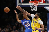 Los Angeles Lakers forward Anthony Davis (3) blocks a shot by Oklahoma City Thunder forward Jeremiah Robinson-Earl (50) during the first half of an NBA basketball game, Wednesday, Oct. 27, 2021, in Oklahoma City. (AP Photo/Garett Fisbeck)