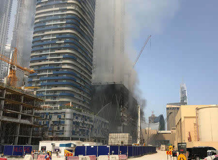 Smoke rises following a fire at a tower under construction in Dubai's Downtown district, United Arab Emirates April 2, 2017. REUTERS/Stringer