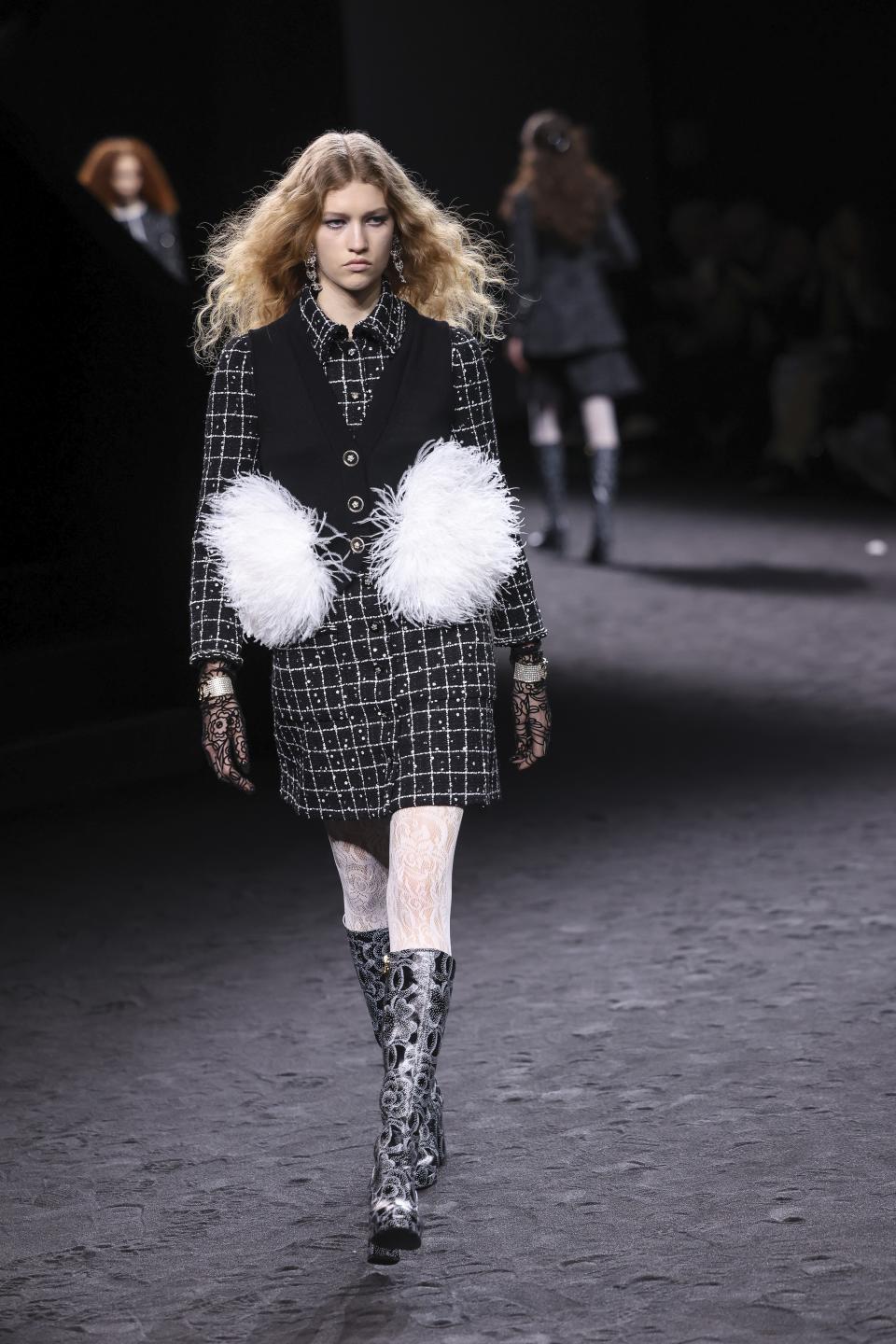 A model wears a creation as part of the Chanel Fall/Winter 2023-2024 ready-to-wear collection presented Tuesday, March 7, 2023 in Paris. (Vianney Le Caer/Invision/AP)