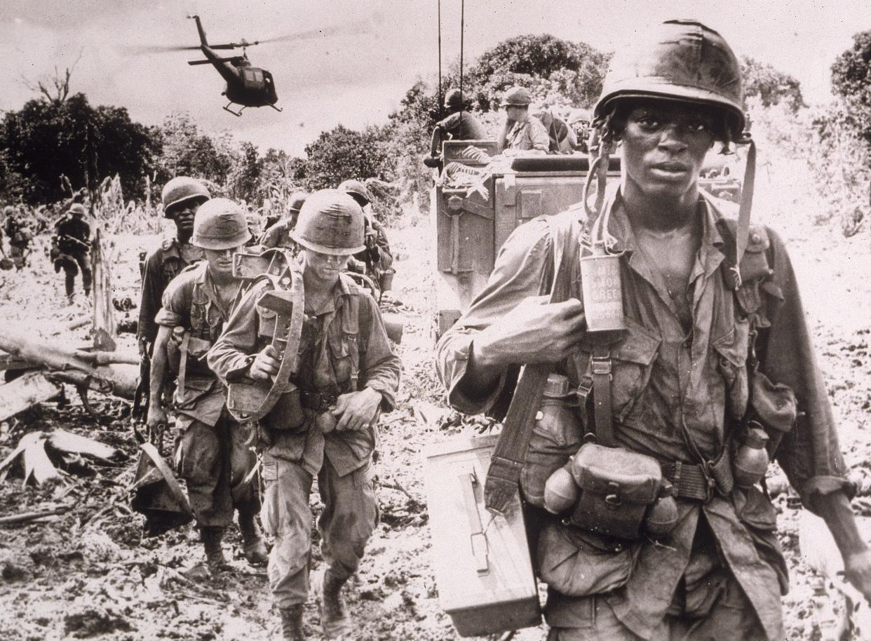 After receiving a fresh supply of ammunition and water flown in by helicopter, men of the US 173rd Airborne Brigade continue on a jungle 'Search and Destroy' patrol in Phuc Tuy Province, Vietnam, June 1966