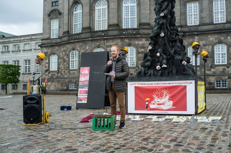 Danish sculptor Jens Galschiot is seen in front of his sculpture "The Pillar of Shame" at the Danish Parliament in Copenhagen