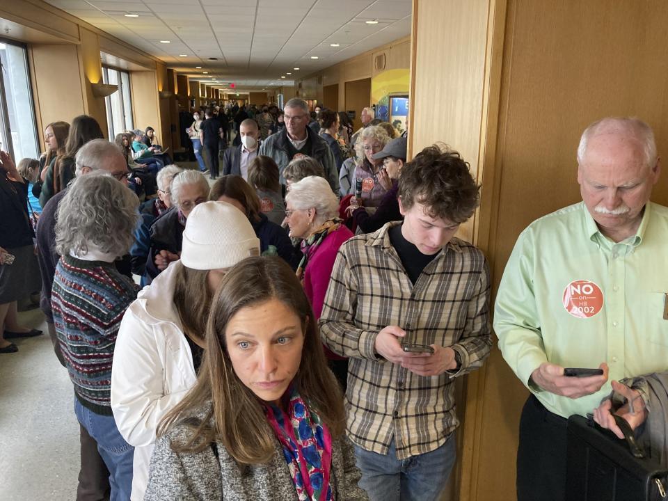 FILE - People line up, March 20, 2023, outside a hearing room in the Oregon state Capital in Salem, Ore., where a public hearing was being held on a bill seeking to expand access to abortion and gender-affirming care. Oregon lawmakers have passed amended versions of the two bills that were at the center of a six-week Republican walkout. One of the bills protects access to abortion and gender-affirming care. The other punishes the manufacturing and sale of untraceable firearms, commonly referred to as ghost guns. (AP Photo/Andrew Selsky, File)