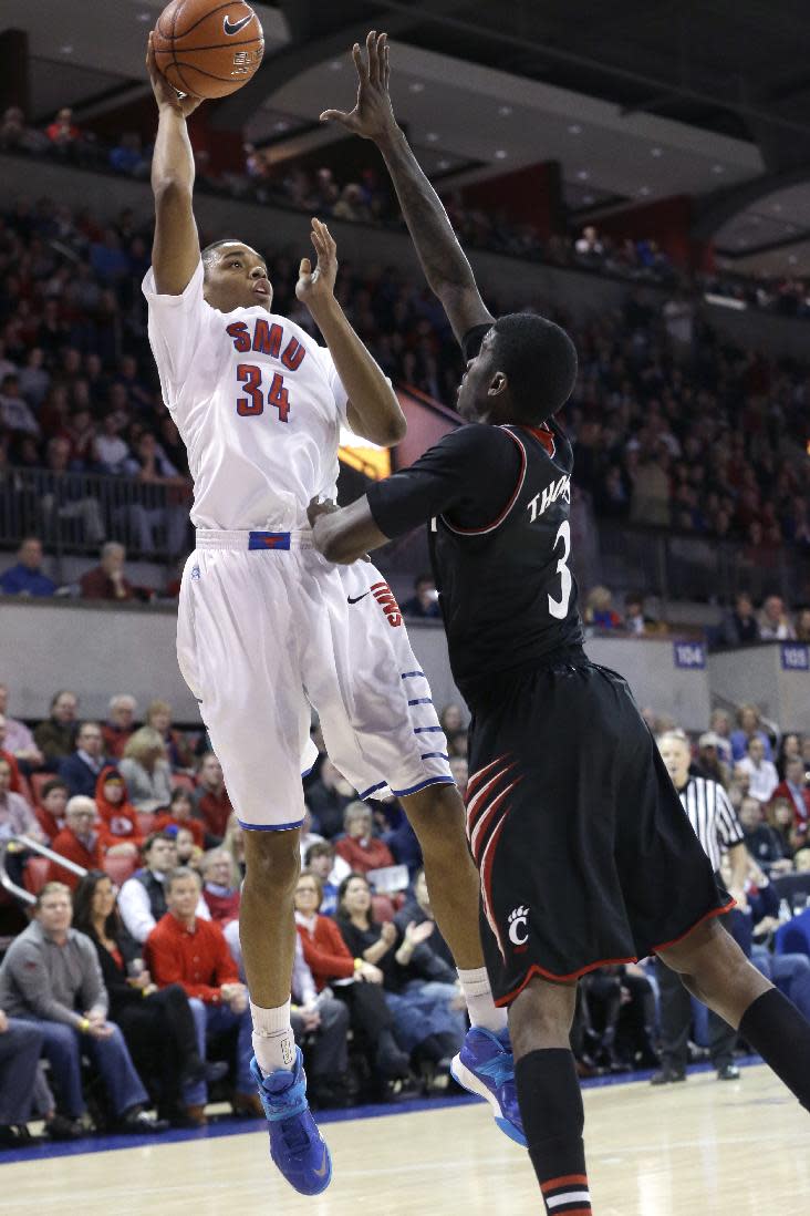 SMU forward Ben Moore (34) shoots against Cincinnati forward Shaquille Thomas (3) during the first half of an NCAA college basketball game Saturday, Feb. 8, 2014, in Dallas. (AP Photo/LM Otero) vcb