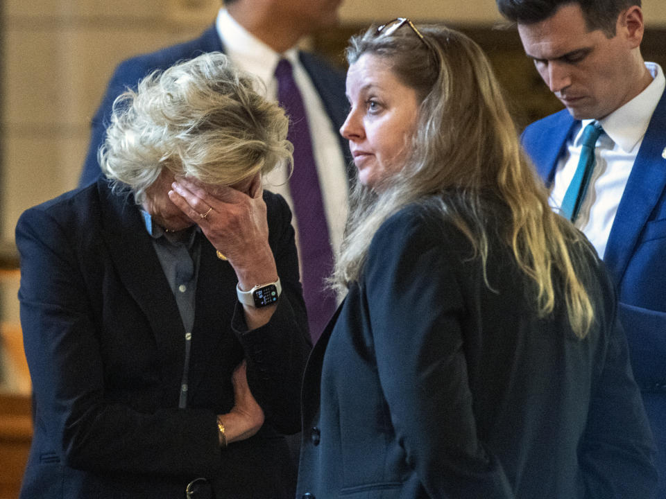 Sen. Lynne Walz, left, puts her head in her hands while meeting with colleagues after giving testimony during a final reading on LB574, the Let Them Grow Act, on Tuesday, May 16, 2023, at State Capitol in Lincoln, Neb. Nebraska lawmakers are debating a plan that would tack on a proposed 12-week abortion ban to a bill (LB574) that would ban gender-affirming care in transgender minors. (Kenneth Ferriera/Lincoln Journal Star via AP)