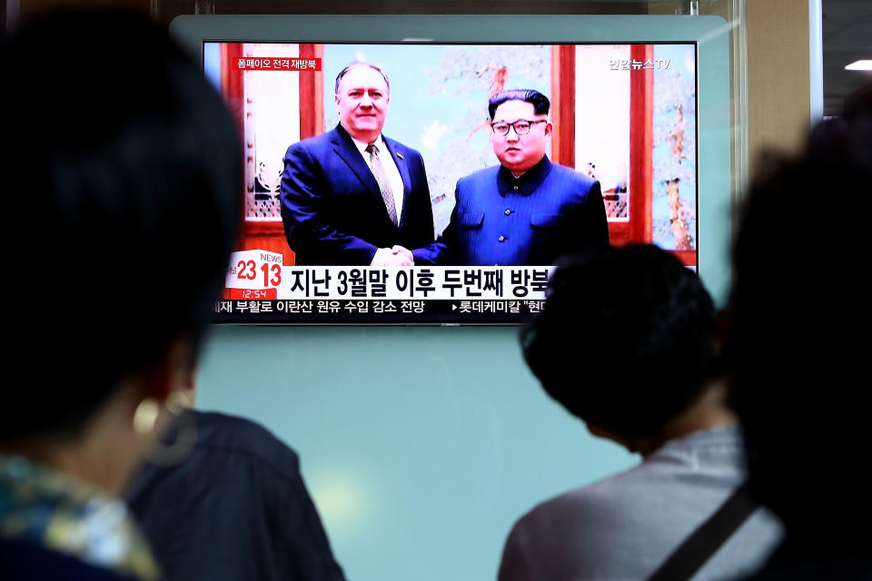 <p>South Koreans watch on a screen reporting the Secretary of State Mike Pompeo visit to North Korea at the Seoul Railway Station on May 9, 2018 in Seoul, South Korea. (Photo: Chung Sung-Jun/Getty Images) </p>