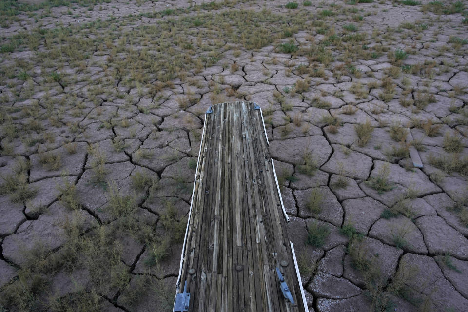 Floating boat docks sit on dry ground as water levels have dropped near the Callville Bay Resort & Marina in the Lake Mead National Recreation Area, Tuesday, Aug. 30, 2022, near Boulder City, Nev. Negotiations over the Colorado River have become increasingly difficult for the seven states that rely on the shrinking river and its reservoirs, including Lake Mead, which is dropping to critically low levels. (AP Photo/John Locher)