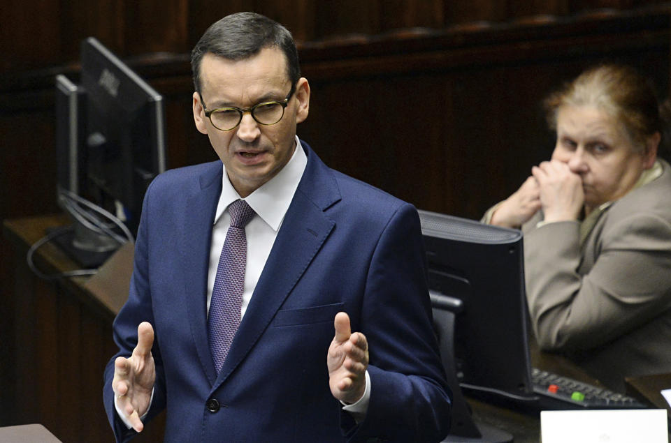 Polish Prime Minister Mateusz Morawiecki speaks in the parliament after he called for a confidence vote in his government, in Warsaw, Poland, Wednesday, Dec. 12, 2018. Morawiecki’s conservative government easily survived a confidence vote in parliament that the leader had unexpectedly asked for earlier in the day. Morawiecki, with the ruling Law and Justice party, had said he wanted to reconfirm that his government has a mandate from lawmakers as it pushes through its “great reforms.”(AP Photo/Alik Keplicz)