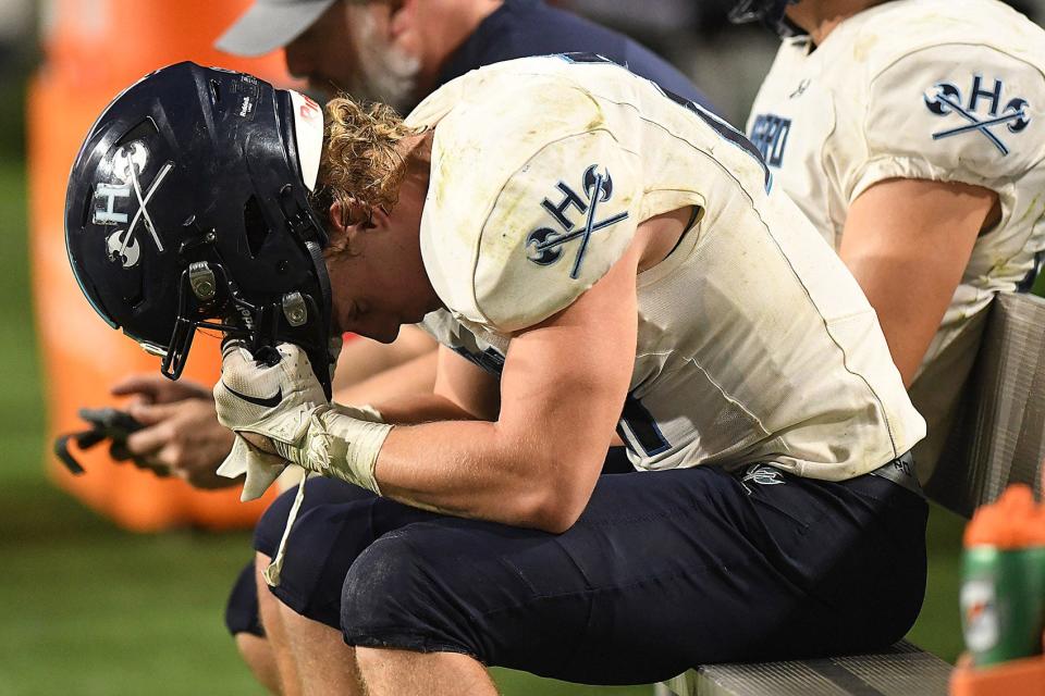Hoggard's #21 Reagan Printy reacts after Hoggard lost to Weddington High School in the 4A Football Championship at Carter-Finley Stadium in Raleigh Saturday Dec. 9, 2023. Weddington beat Hoggard 56 -21 to win the State Championship. KEN BLEVINS/STARNEWS