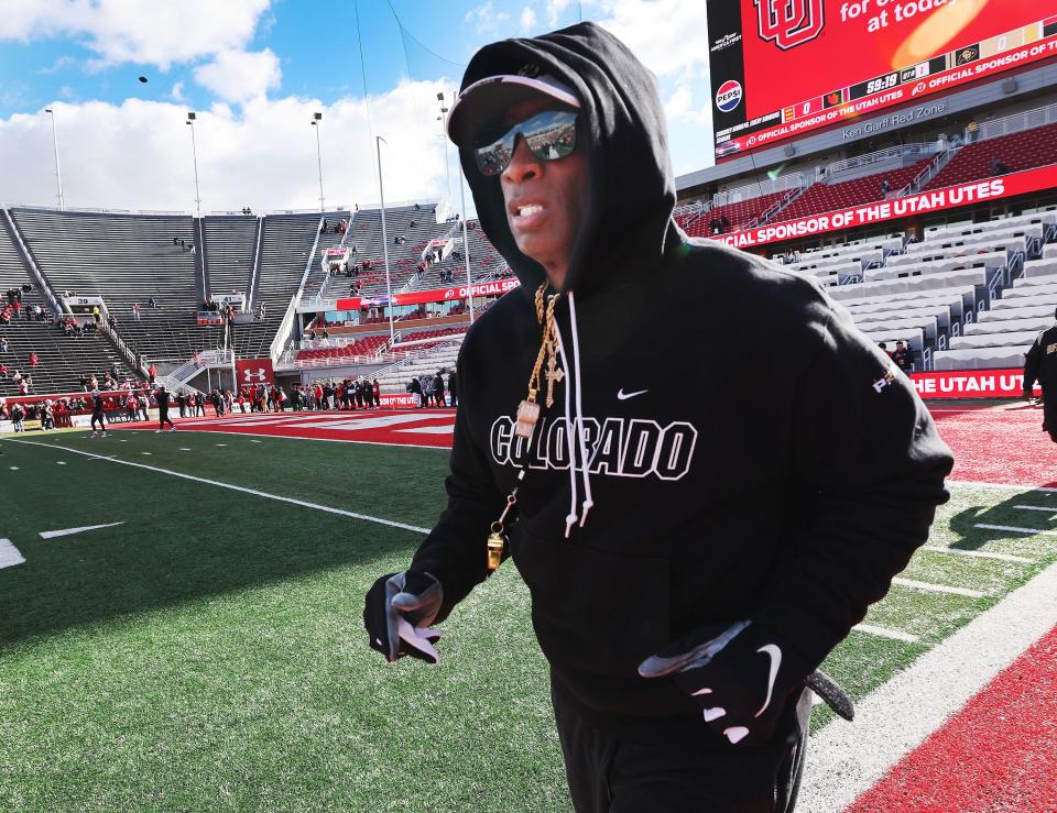 Colorado Buffaloes head coach Deion Sanders runs onto the field in Salt Lake City on Saturday, Nov. 25, 2023. | Jeffrey D. Allred, Deseret News