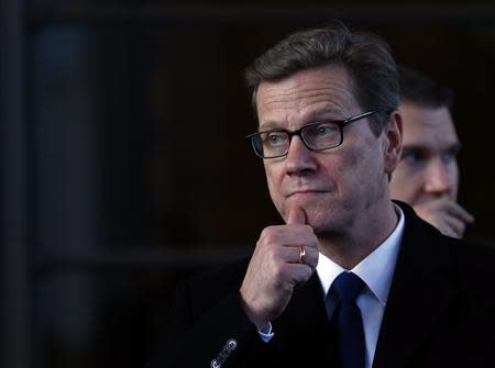 Germany's Foreign Minister Guido Westerwelle gestures as he leaves the Intercontinental hotel on the third day of closed-door nuclear talks with Iran in Geneva November 9, 2013. REUTERS/Denis Balibouse