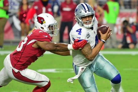 Sep 25, 2017; Glendale, AZ, USA; Dallas Cowboys quarterback Dak Prescott (4) escapes a tackles from Arizona Cardinals linebacker Haason Reddick (43) during the second half at University of Phoenix Stadium. Mandatory Credit: Matt Kartozian-USA TODAY Sports