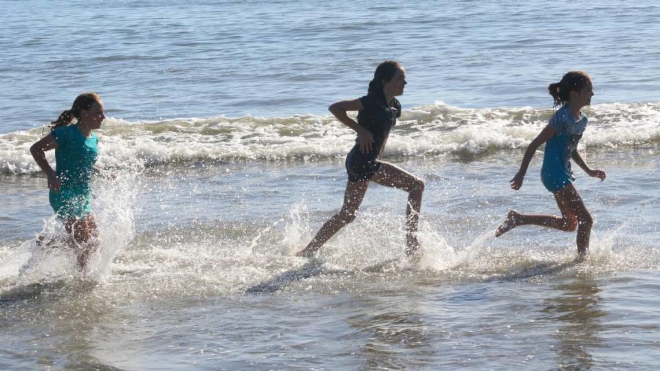 Avila Beach was a great place to be as a late October heatwave hit San Luis Obispo County. Running in the surf are, from left, Kathryn King, 11, Nayeli Schmidt, 13, and Eliora Schmidt,11.
