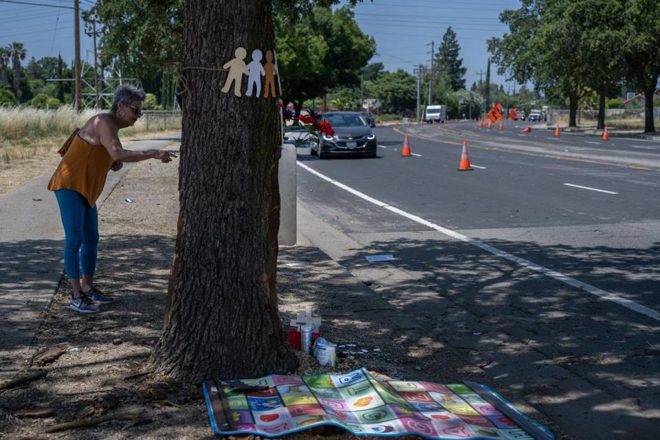 Marbella Sala, president of the Gardenland Northgate Neighborhood Association, speaks Thursday, June 1, 2023, about how dangerous the road was at the scene of a car crash on San Juan Road in Sacramento where three people died and eight more are injured the night before. At least two dozen crashes have occurred at the same curve since 2011.