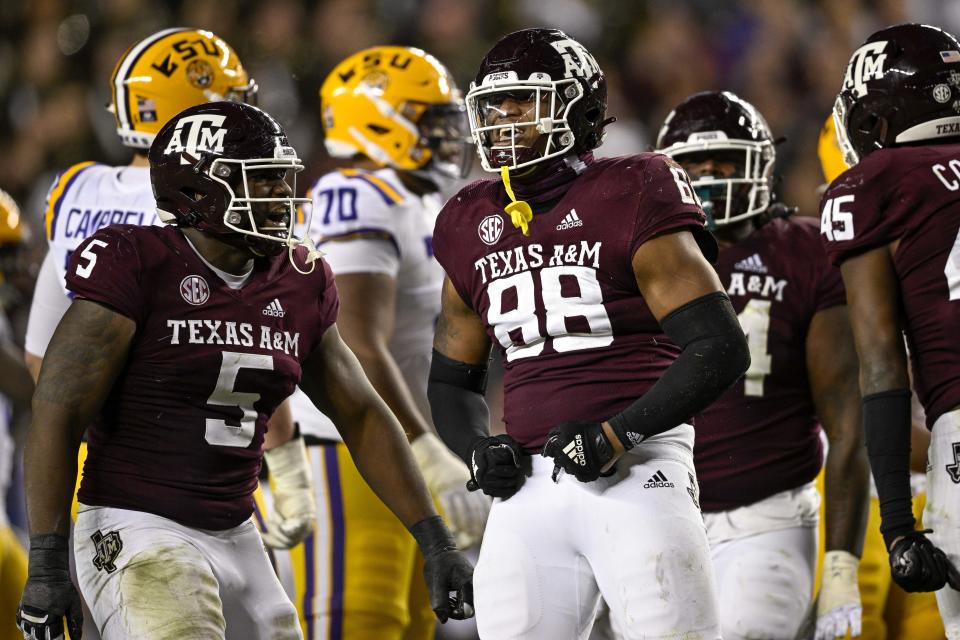 Nov 26, 2022; College Station, Texas; Texas A&M Aggies defensive lineman Walter Nolen (88) and defensive lineman Shemar Turner (5) celebrate a defensive stop against the LSU Tigers during the second half at Kyle Field. Jerome Miron-USA TODAY Sports