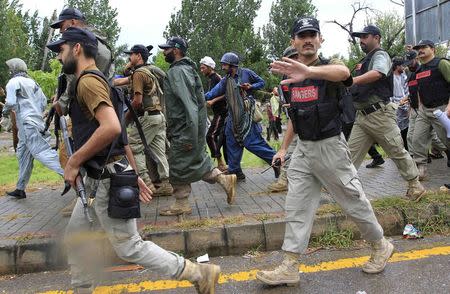 A soldier from the Pakistan Rangers gestures to stop members of the media while walking with supporters of Tahir ul-Qadri, Sufi cleric and leader of political party Pakistan Awami Tehreek (PAT), during Revolution March towards the prime minister's house in Islamabad September 1, 2014. REUTERS/Faisal Mahmood