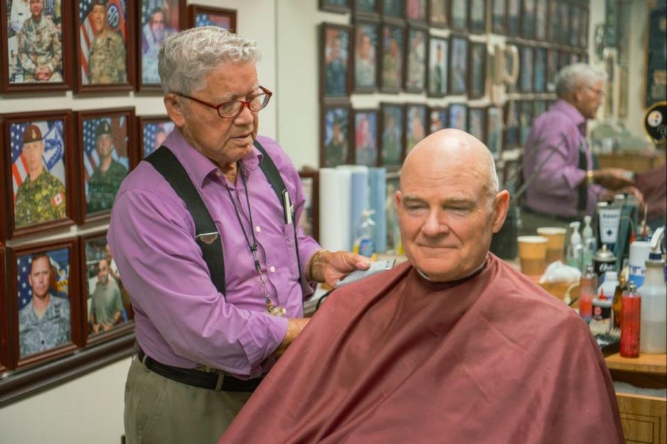 Travis Bell, 18th Airborne Corps barber, cuts the hair of one of his regular customers June 20, 2024, at Fort Liberty.