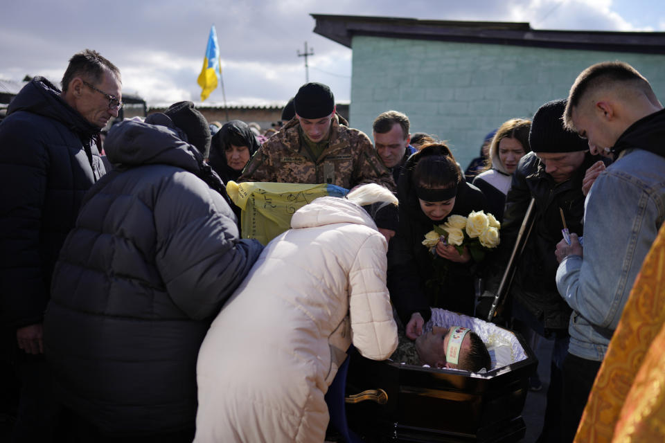 Inna, 22, cries over the body of his boyfriend, Vladyslav Bondarenko 26, during his funeral in Kozyntsi, near Kyiv, Ukraine, Monday, March 6, 2023. Bondarenko, a paratrooper of airmobile brigade, died near Bakhmut on Feb 26. (AP Photo/Thibault Camus)
