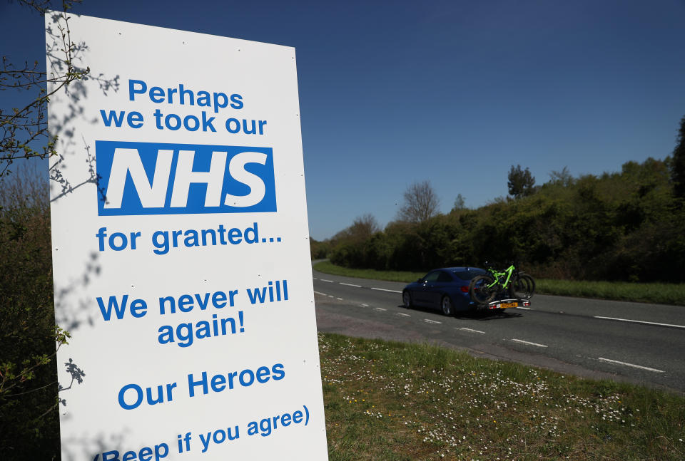 A car makes it's way past a sign in support of the NHS put up on the A30 near to Old Basing in Hampshire, as the UK continues in lockdown to help curb the spread of the coronavirus.