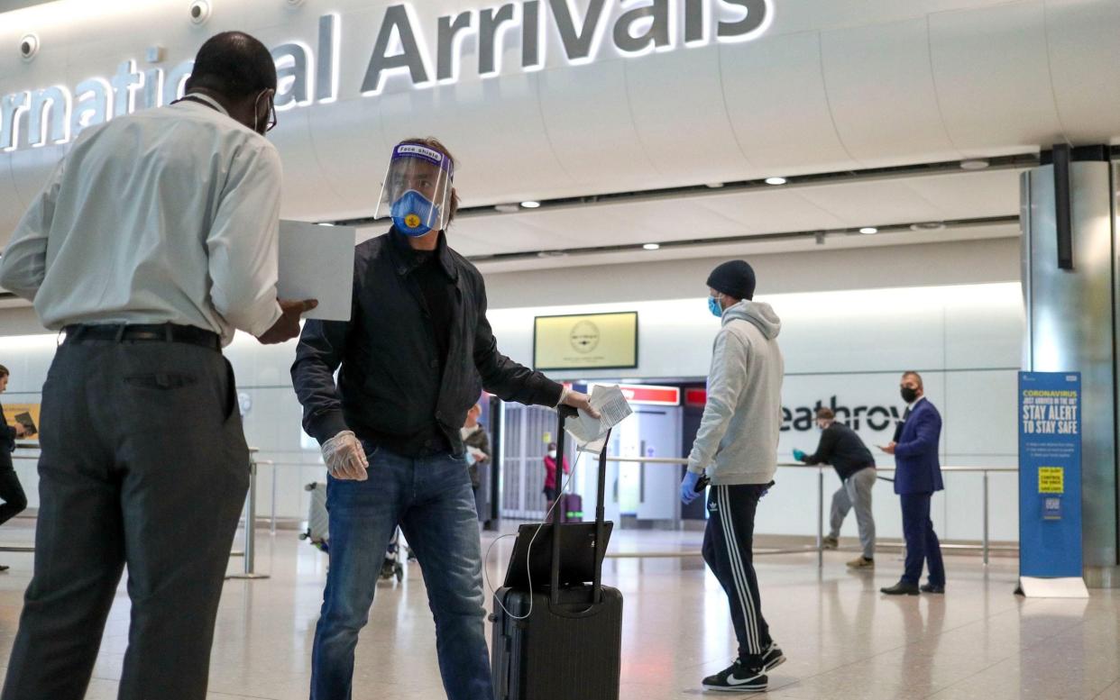 Passengers arriving at Terminal 2 at Heathrow Airport in London, as new quarantine measures for international arrivals came into force in June - PA