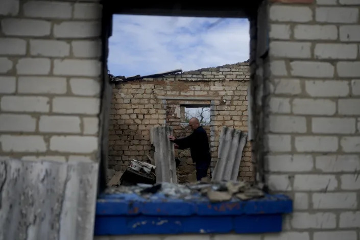Eduard Zelenskyy walks inside his home destroyed by attacks in Potashnya, on the outskirts of Kyiv, Ukraine, Tuesday, May 31, 2022. Zelenskyy just returned to his home town after escaping war to find out he is homeless. (AP Photo/Natacha Pisarenko)