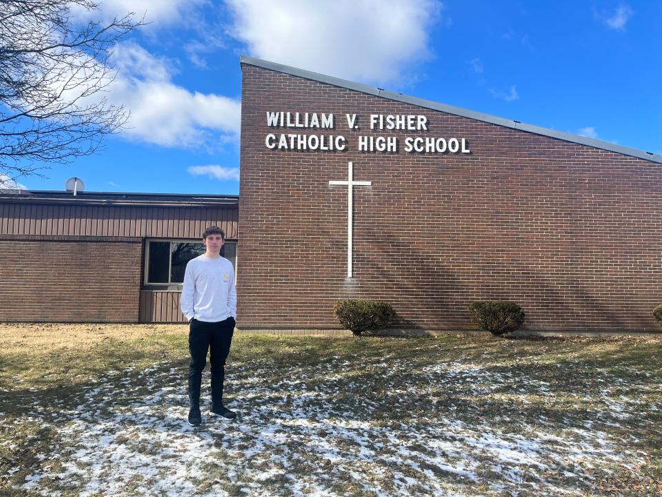 Student Justin Viau stands in front of William V. Fisher Catholic High School in Lancaster.