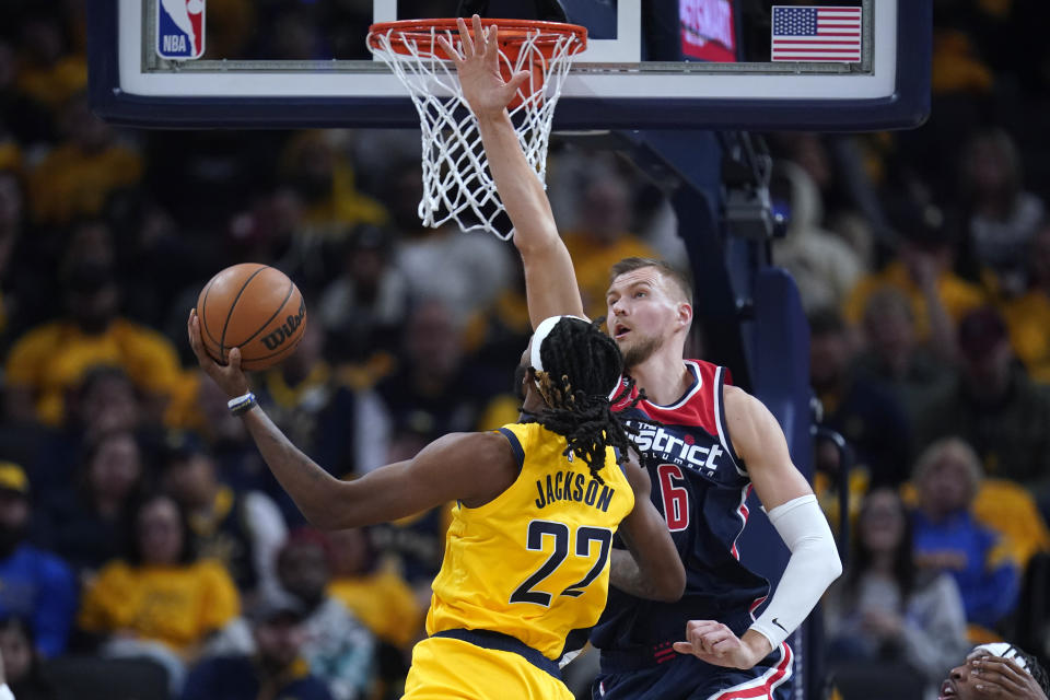 Indiana Pacers' Isaiah Jackson (22) shoots against Washington Wizards' Kristaps Porzingis during the first half of an NBA basketball game Wednesday, Oct. 19, 2022, in Indianapolis. (AP Photo/Michael Conroy)