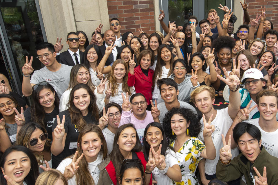 Recording artist Andre "Dr. Dre" Young, rear left, and record producer, Jimmy Iovine, rear center, the music business partners pose along with USC students during the official opening and dedication of the Jimmy Iovine and Andre Young Academy building at the University of Southern California, Wednesday, Oct 2, 2019, in Los Angeles. The building was named after Iovine and Dr. Dre who donated a combined $70 million in 2013 to create the Jimmy Iovine and Andre Young Academy for Innovation. (Gus Ruelas/University of Southern California via AP)