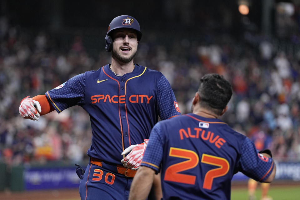 Houston Astros' Kyle Tucker celebrates with Jose Altuve (27) after hitting a two-run home run during the first inning of a baseball game against the Toronto Blue Jays, Monday, April 1, 2024, in Houston. (AP Photo/Kevin M. Cox)