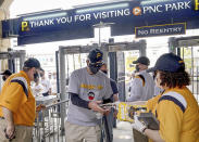 Fans enter PNC Park before the Pittsburgh Pirates take on the Chicago Cubs in the Pirates home opening baseball game at PNC Park in Pittsburgh, Thursday, April 8, 2021. (Matt Freed/Pittsburgh Post-Gazette via AP)
