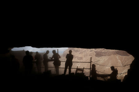 Volunteers with the Israeli Antique Authority work at the Cave of the Skulls, an excavation site in the Judean Desert near the Dead Sea, Israel June 1, 2016. REUTERS/Ronen Zvulun