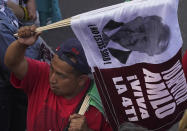 A supporter of Mexican President Andrés Manuel López Obrador takes part in a rally at the capital's main square, the Zócalo, to commemorate the 85th anniversary of the 1938 expropriation of the country's oil industry in Mexico City, Saturday, March 18, 2008. (AP Photo/Marco Ugarte)