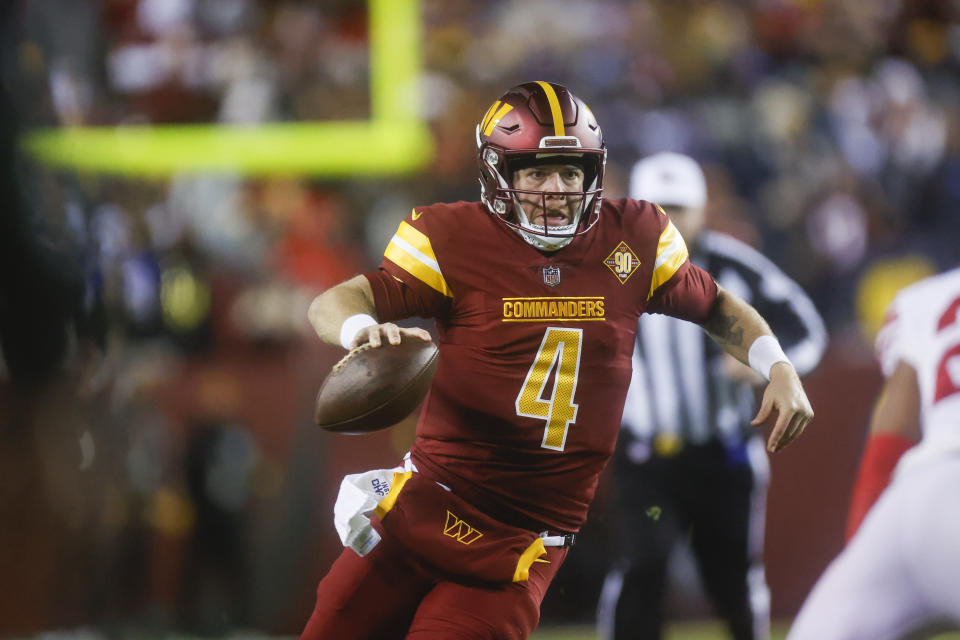 Washington Commanders quarterback Taylor Heinicke (4) carries the ball during the second half of a NFL football game between the New York Giants and the Washington Commanders on Sunday, Dec. 18, 2022 at FedExField in Landover, Md. (Shaban Athuman/Richmond Times-Dispatch via AP)