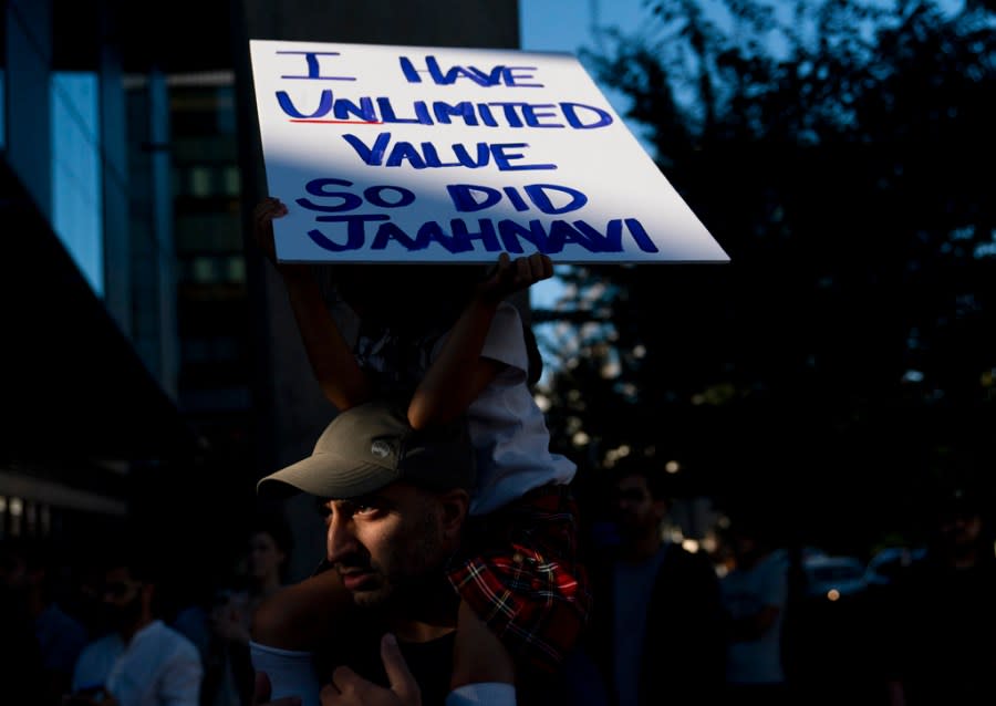 Layla Allibhai, 5, sits atop father Mo Allibhai’s shoulders while holding a sign for Jaahnavi Kandula, a 23-year-old woman hit and killed in January by officer Kevin Dave in a police cruiser, as people protest after body camera footage was released of a Seattle police officer joking about Kandula’s death, Thursday, Sept. 14, 2023, in Seattle. (AP Photo/Lindsey Wasson)