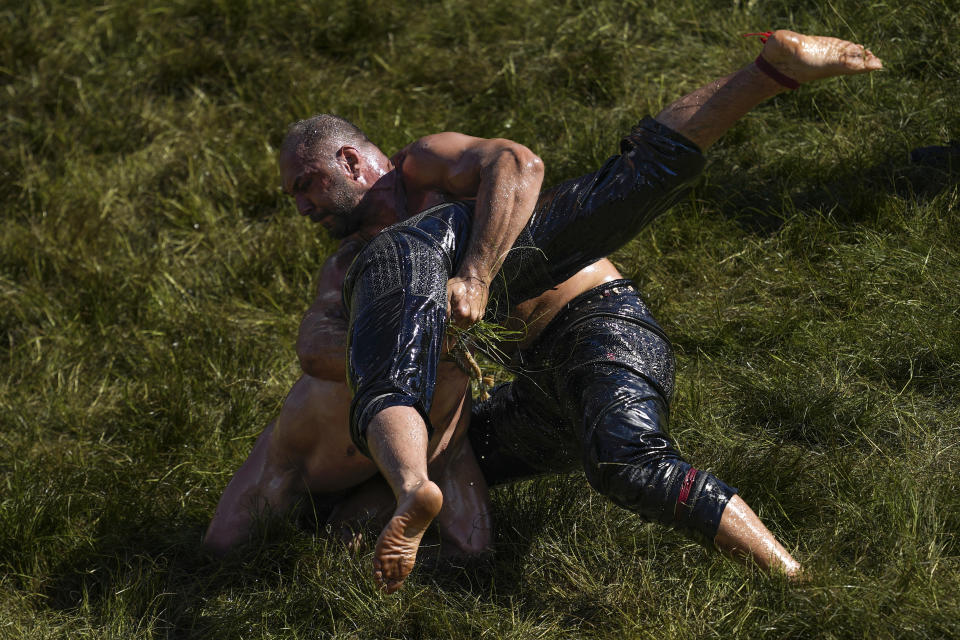 Wrestlers compete during the 663rd annual Historic Kirkpinar Oil Wrestling championship, in Edirne, northwestern Turkey, Saturday, July 6, 2024. Wrestlers take part in this "sudden death"-style traditional competition wearing only a pair of leather trousers and a good slick of olive oil. The festival is part of UNESCO's List of Intangible Cultural Heritages. (AP Photo/Khalil Hamra)