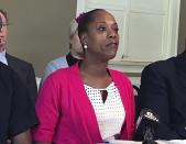 FILE - In this Aug. 18, 2017, file photo, Demetria Hester speaks during a press conference in Portland, Ore. Hester, 46, was booked on suspicion of disorderly conduct and interfering with a police officer during a protest that began Sunday night, Aug. 9, 2020 and stretched into the early morning hours. Hester was assaulted by a white supremacist in a high-profile case three years ago and who now leads a group of “moms” in racial justice protests each night. (AP Photo/Steven DuBois, File)