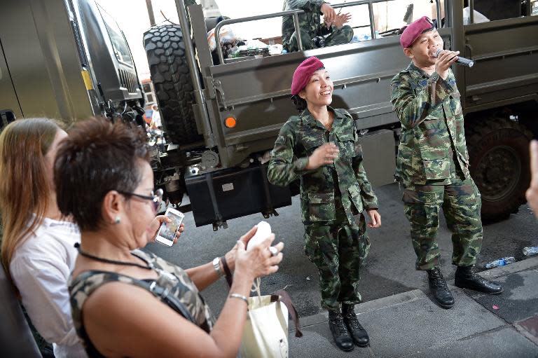 Soldiers sing and dance with residents at a military event organised to 'return happiness to the people' at Victory Monument, the site of recent anti-coup rallies in Bangkok, on June 4, 2014