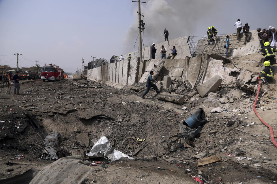 Afghan firefighters work at the site of Monday's suicide bomb attack in Kabul, Afghanistan, Tuesday, Sept. 3, 2019. The attack occurred late Monday near the the Green Village, home to several international organizations and guesthouses. (AP Photo/Rahmat Gul)