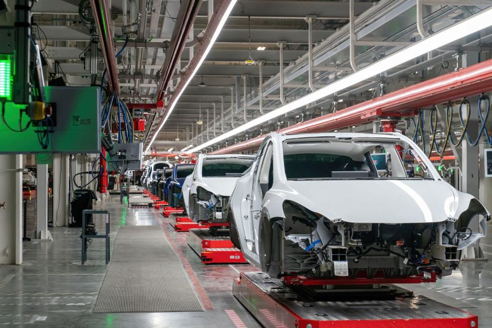 tesla giga texas factory with model y bodies on assembly line