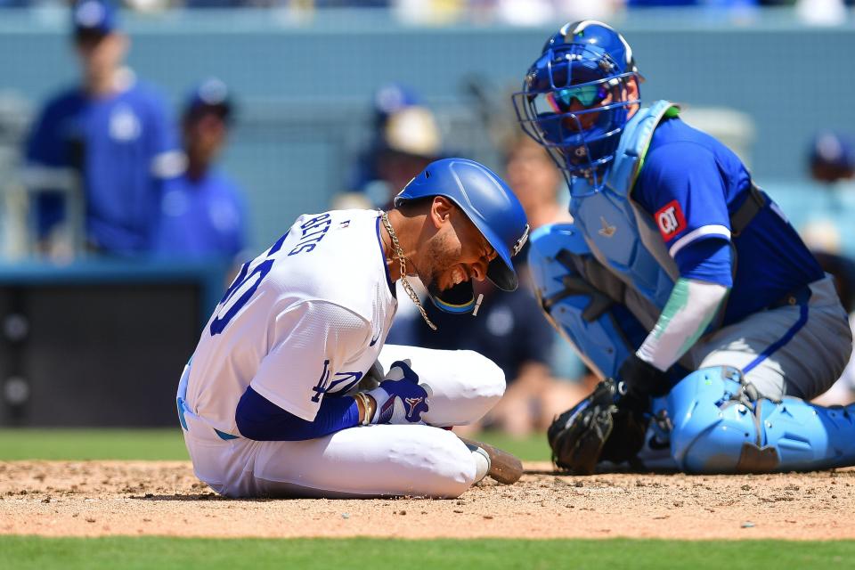 Mookie Betts reacts after being hit by pitch from Kansas City Royals pitcher Dan Altavilla during the seventh inning at Dodger Stadium.