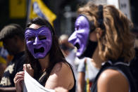 Theatre workers protest outside the National Theatre, against the mass redundancies of low-paid art jobs due to the Coronavirus outbreak, in London, Saturday, Aug. 1, 2020. Prime Minister Boris Johnson put some planned measures to ease the U.K.'s lockdown on hold Friday, saying the number of new coronavirus cases in the country is on the rise for the first time since May. He called off plans to allow venues, including casinos, bowling alleys and skating rinks, to open from Saturday, Aug. 1. (AP Photo/Alberto Pezzali)