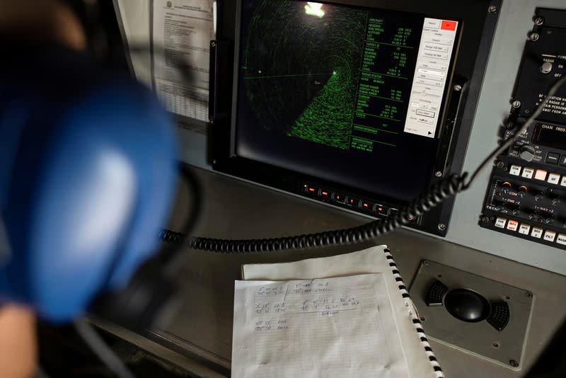 An Ecuadorian navy officer looks at a radar after a fishing fleet of mostly Chinese-flagged ships was detected in an international corridor that borders the Galapagos Islands' exclusive economic zone, in the Pacific Ocean