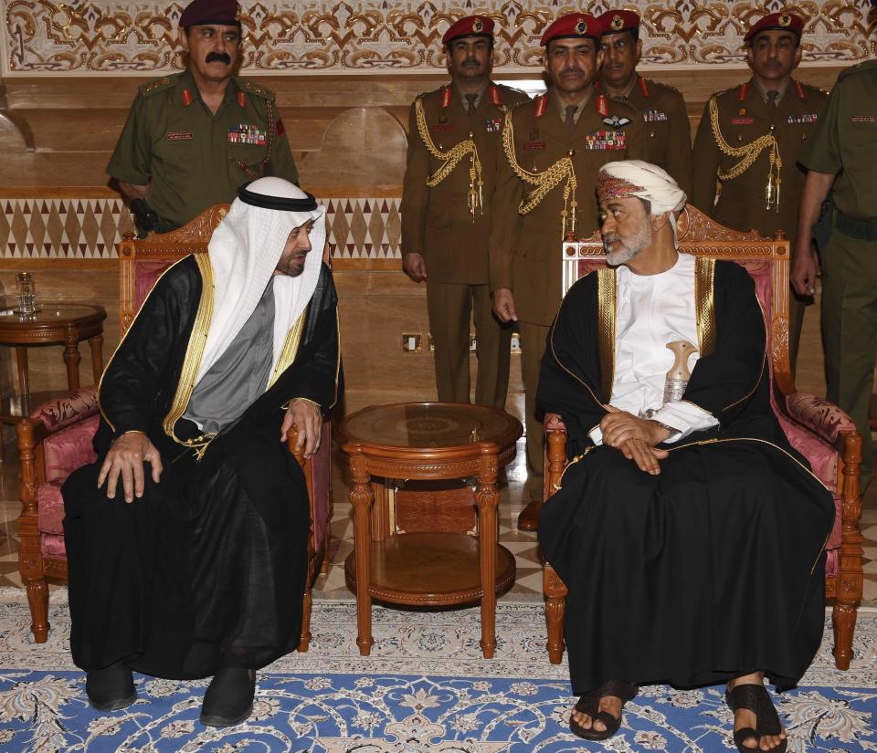 In this photo made available by Oman News Agency, Oman's new Sultan Haitham bin Tariq Al Said, right, receives Sheikh Mohammed bin Zayed Al Nahyan, the Crown Prince of the Emirate of Abu Dhabi and Deputy Supreme Commander of the United Arab Emirates Armed Forces, after his arrival to attend the late Sultan Qaboos official mourning ceremony in Muscat, Oman, Sunday, Jan. 12, 2020. (Oman News Agency via AP)