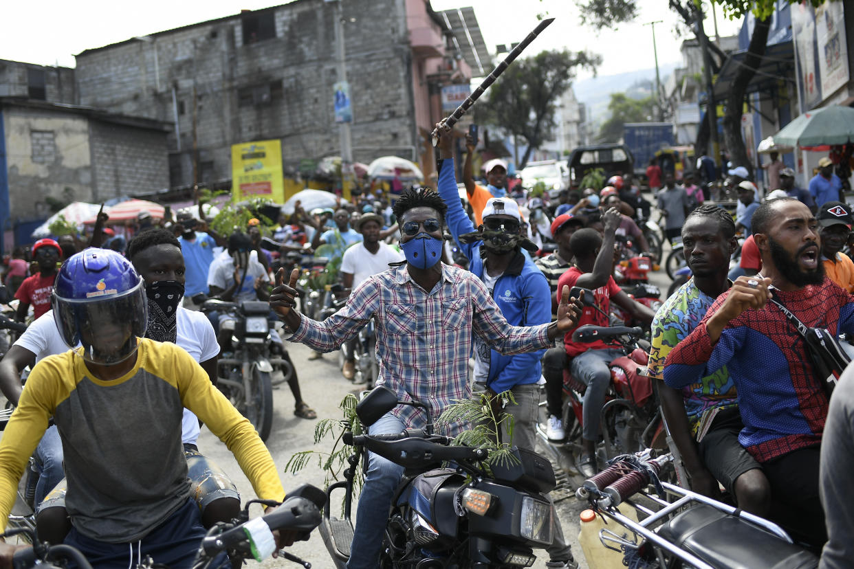 FILE - Motorcyclists unable to buy gas to fill their tanks ride in protest to the home of acting Prime Minister Ariel Henry, in Port-au-Prince, Haiti, Oct. 19, 2021. The U.S. government is urging U.S. citizens to leave Haiti given the country’s deepening insecurity and a severe lack of fuel that has affected hospitals, schools and banks. Gas stations remained closed on Thursday, Nov. 11, 2021, a day after the State Department issued its warning. (AP Photo/Matias Delacroix, File)