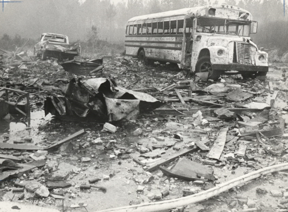 A destroyed truck and school bus sit amongst the rubble of building M132 at the Thiokol Chemical plant in Woodbine, Georgia, on Feb. 3, 1971. The explosion killed 30 people and injured several others.