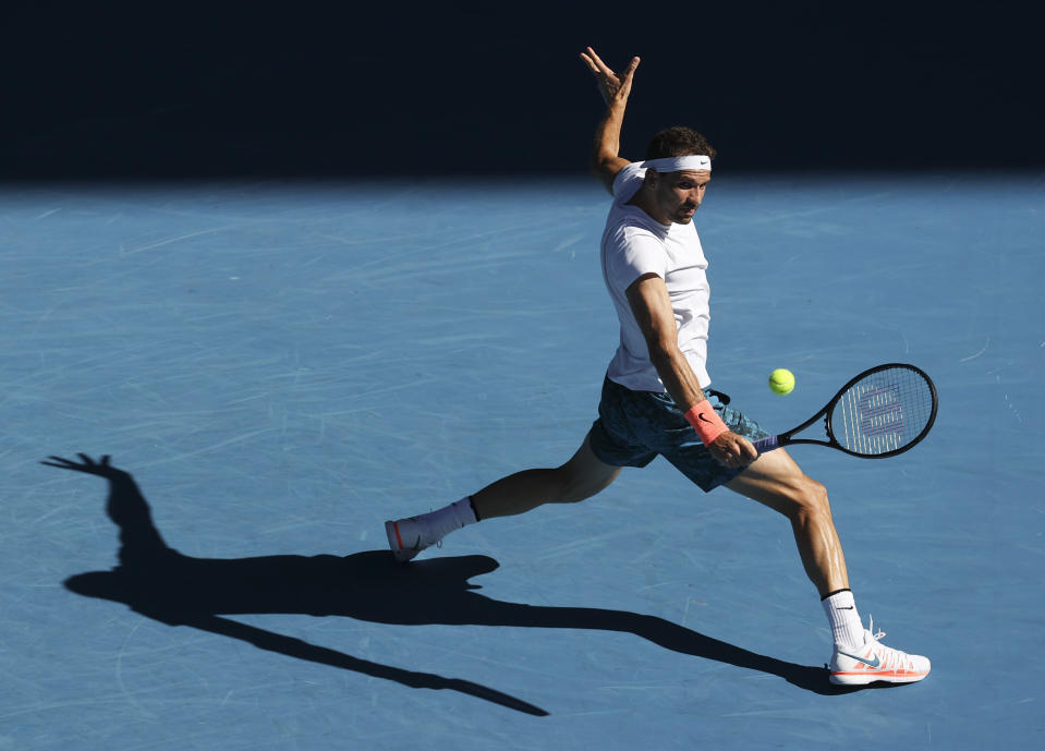 Buglaria's Grigor Dimitrov hits a backhand return to Austria's Dominic Thiem during their fourth round match at the Australian Open tennis championship in Melbourne, Australia, Sunday, Feb. 14, 2021.(AP Photo/Hamish Blair)