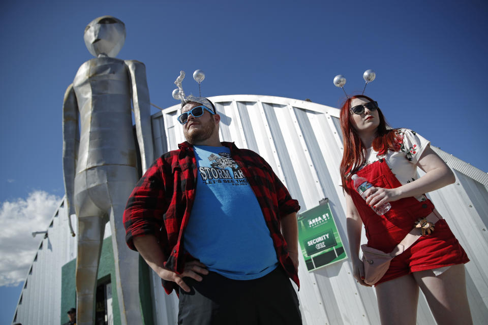 Jackson Carter and Veronica Savage wait for passes to enter the Storm Area 51 Basecamp event Friday, Sept. 20, 2019, in Hiko, Nev. The event was inspired by the "Storm Area 51" internet hoax. (AP Photo/John Locher)